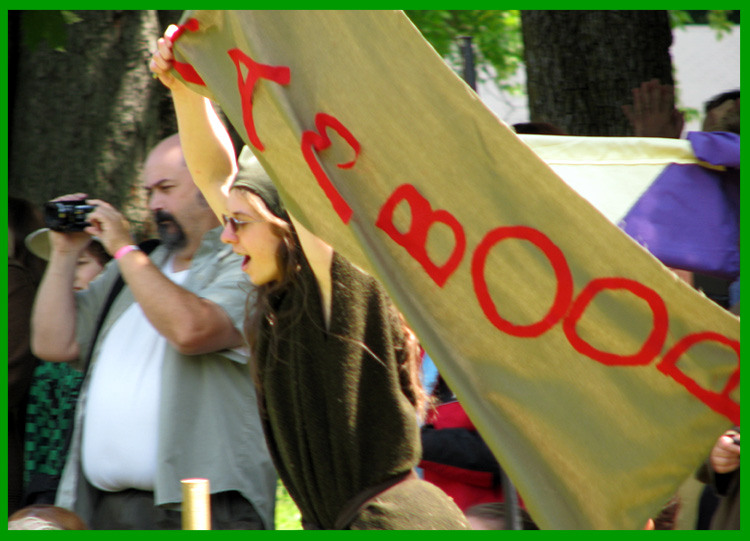 Crispin runs around the ring with the banner